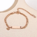 Rose gold stainless steel bar bracelet with heart charm on a minimalist white display - Rose Gold