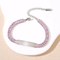 Macro shot of silver stainless steel bracelet featuring pink cubic zirconia and engravable plate - Silver Pink Stone