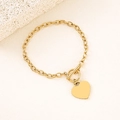 Detailed close-up of a polished gold heart pendant with OT toggle clasp on a link chain - Gold 20mm Fan-Hole Heart Toggle Bracelet