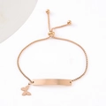 Detail of rose gold adjustable box chain bracelet with engraved bar and butterfly charm - Butterfly (Rose Gold) / Rose Gold