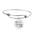 Detailed macro view of silver stainless steel bangle with engraved circular charm - KEEP fucking GOING (Y00003)