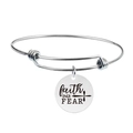 Detail view of stainless steel bangle featuring engraved faith OVER FEAR round pendant charm - faith OVER FEAR (Y00015)