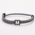 Adjustable grey Milan rope bracelet featuring a square bead with white letter M engraving - Letter M (SLF013) / Gray