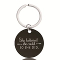 Detail of round black stainless steel keychain with engraved She Believed She Could quote - Self-Motivation Style (Y00012)
