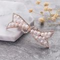 Fermaglio per capelli a fiocco oro rosa con strass e perle su base di marmo - Fiocco Asimmetrico