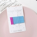 Set of 12 blue minimalist hair clips with pink round tips on a white display card - Lake Blue