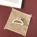 Detailed macro view of luxurious gold-tone alloy hair claw with white pearl accents - Small Pearl Arch