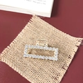 Detail of luxury gold hair claw clip with rows of sparkling rhinestones on linen fabric - Small Rhinestone Square