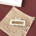 Detail of luxury pearl and rhinestone hair claw clip on vintage fabric background - Small Pearl Square
