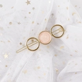 Detailed close-up of a golden geometric hair clip with pink marble inlay on lace - Round Pink