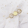 Detail of a gold alloy hair clip with circular resin texture on star mesh background - Round Yellow