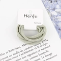 Detail of high-elasticity hair bands in soft sage green on white brand display card - Mint Green