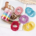 Close-up of vibrant elastic hair ties in assorted candy colors with a clear storage jar - Thin Style Candy Colors