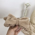 Macro detail of soft brown fleece headband with a large bow for skincare and makeup - Khaki