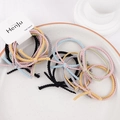 Detailed view of colorful knitted elastic hair bands with knots in a ceramic bowl - Two-Tone Knot Mixed Colors