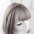 Close-up of matte brown wavy headband with anti-slip teeth shown on a model - Khaki