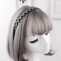 Detail of matte dark grey wavy zigzag headband with non-slip teeth on model - Blue Gray