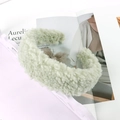 Detail of light green faux lamb wool headband with soft fluffy texture on a magazine - Mint Green