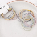 Macro view of macaron hair bands with star and moon patterns on a ceramic plate - Star Moon Mixed Colors
