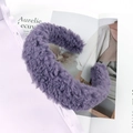 Close-up of a soft purple lamb wool headband on a magazine for winter styling - Purple