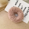 Detail of soft faux rabbit fur hair scrunchie in dusty pink on a stone tray - Korean Pink