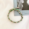 Detail of hand-woven braided hair tie in green, brown and beige colors with a soft texture - Coffee Beige Green