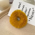 Close-up of a fluffy ginger yellow faux fur scrunchie on a minimalist cream background - Ginger Yellow