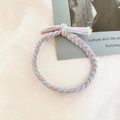 Detail of pink and blue hand-braided elastic hair tie with cute knot and tassel design - Tiffany Blue