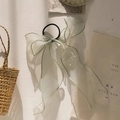 Detail of light green organza bow hair scrunchie with long ribbons and elastic band - Light Green