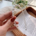Detailed view of elegant gradient white pearl headband with soft polished finish - 2# Interspersed Beads White