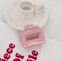 Close-up of pink square matte hair claw clip with speckled resin texture for styling - Square (Pink Spotted) / Pink