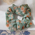 Floral scrunchie in mint green with orange and white blossom pattern on soft fabric - Lake Green