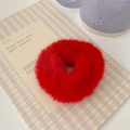 Close-up of soft red plush scrunchie with a fuzzy texture on a cozy background - Red