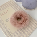 Close-up of soft pink plush scrunchie on notebook, highlighting fluffy texture and pastel color - Dusty Pink