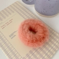 Detailed macro view of a fluffy pink coral plush scrunchie on a checkered notebook - Watermelon Pink