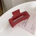 Detail of large matte dark red rectangular hair claw clip with floral accent and artistic card - Burgundy
