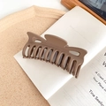 Close-up of matte coffee brown hair claw clip on book with 10 teeth for styling - Brown