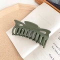 Detail of large matte olive green shark hair claw clip with multi-tooth design for styling - Avocado Green