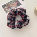 Macro shot of vintage plaid hair scrunchie with navy and red wool texture detail - Black and Red Series
