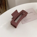 Detailed macro view of large matte rectangular hair claw clip in deep mahogany finish - Dark Red