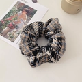 Detailed close-up of vintage houndstooth fabric texture on a plush oversized scrunchie - Yellow and Black Series