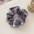 Detailed shot of a vintage plaid wool scrunchie featuring blue, red, and white patterns - Blue and Beige Series