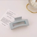 Detailed macro view of light blue square matte hair claw clip with speckled texture finish - Speckled Blue