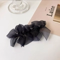 Detail of layered black organza bow hair clip with sheer mesh texture and elegant design - Black