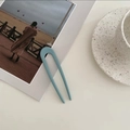 Detail of matte blue U-shaped hair pin for women on a stylish aesthetic magazine background - Fog Blue