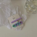 Detail of candy color purple and mint green chain hair clips on a display card - Blue and Purple