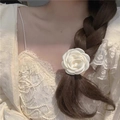 Eleganter weißer Kamelien-Haargummi auf geflochtenem Haar im französischen Minimal-Stil - Kamelie Haargummi