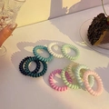 Colorful spiral phone cord hair ties in macaroon colors set on a white surface - Mixed Colors