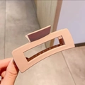 Close-up of a large matte square claw clip in soft milk tea pink for thick hair styling - Large Matte Style / Milk Tea