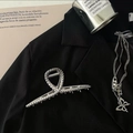 Silver metal hair claw and layered necklace displayed on a black blazer jacket - Silver Hammered Texture Claw